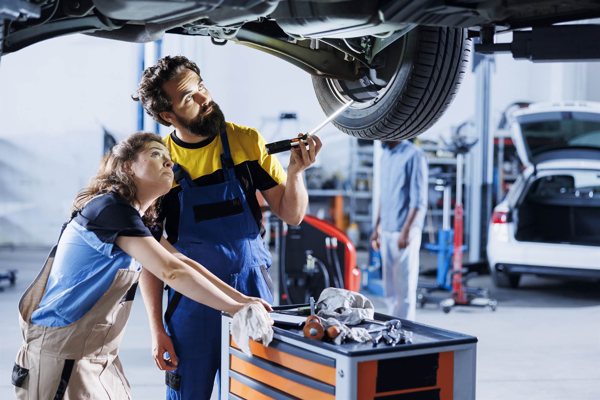Mechanics inspecting tires in a repair shop